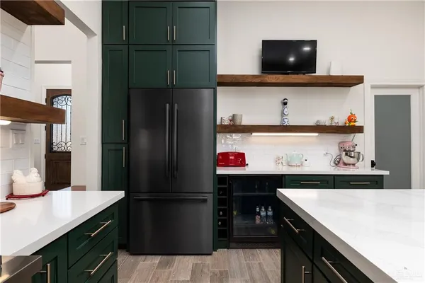 a kitchen with a refrigerator and a stove