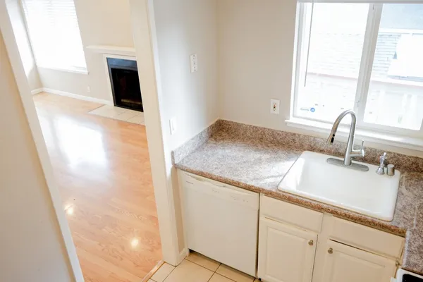 a kitchen with a sink and a mirror