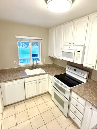 a kitchen with a stove a sink and a refrigerator