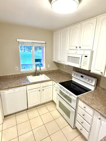 a kitchen with a stove a sink and a refrigerator