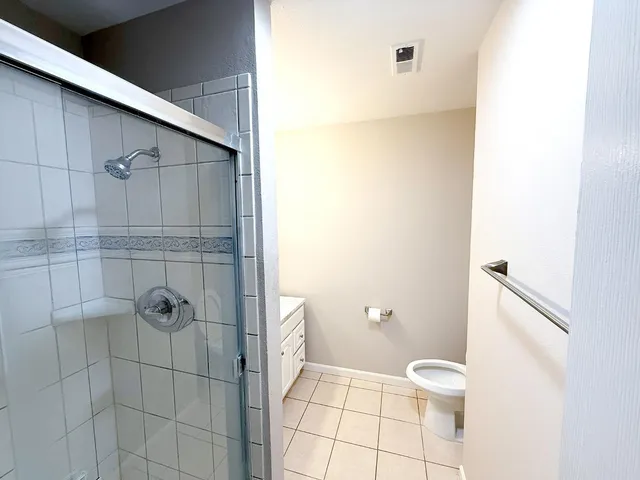 a bathroom with a toilet and a shower