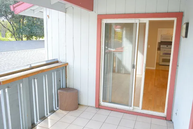a view of a door and chair in a room