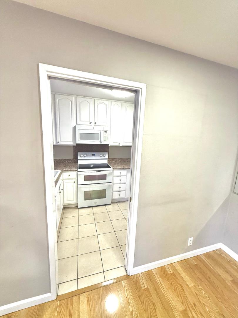 84 Rancho Drive, Unit H San Jose, CA 95111 - Photo 9 of 16 a view of a kitchen with wooden floor and a kitchen space