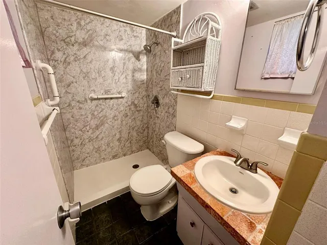 a bathroom with a sink toilet and shower