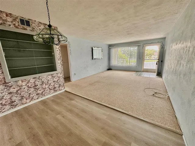 a view of empty room with window and fireplace