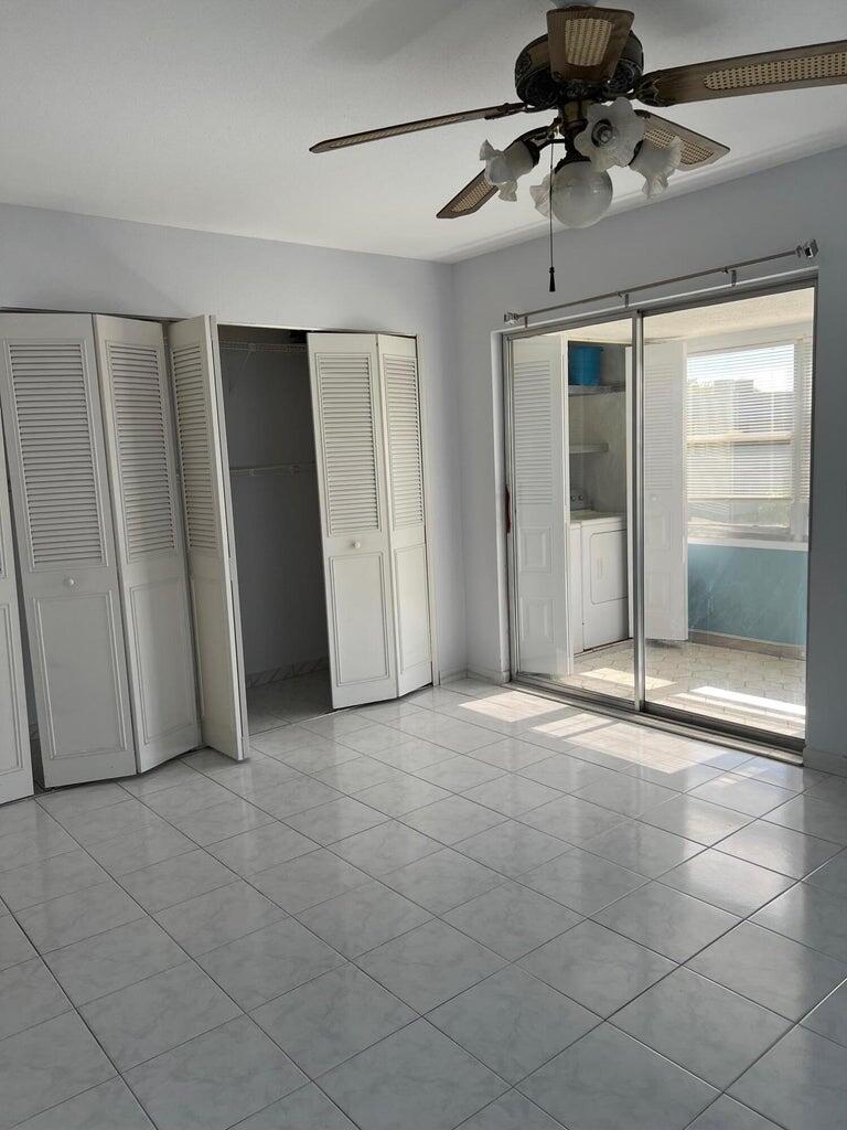 371 Flanders South, Unit 371 Delray Beach, FL 33484 - Photo 13 of 17 a view of a livingroom with a chandelier fan and windows