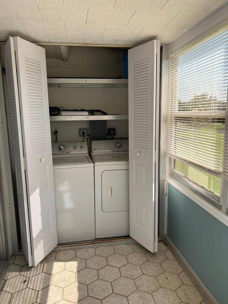 371 Flanders South, Unit 371 Delray Beach, FL 33484 - Photo 4 of 17 a utility room with a washer and dryer