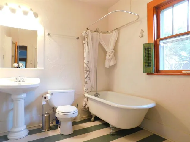 a bathroom with a toilet sink and a shower