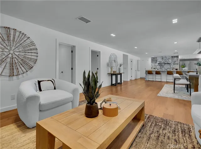a kitchen with stainless steel appliances kitchen island granite countertop a table and chairs