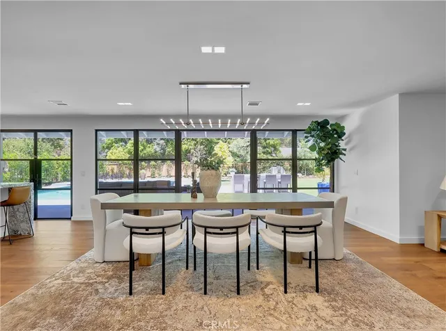 a kitchen with stainless steel appliances a refrigerator and a white cabinets