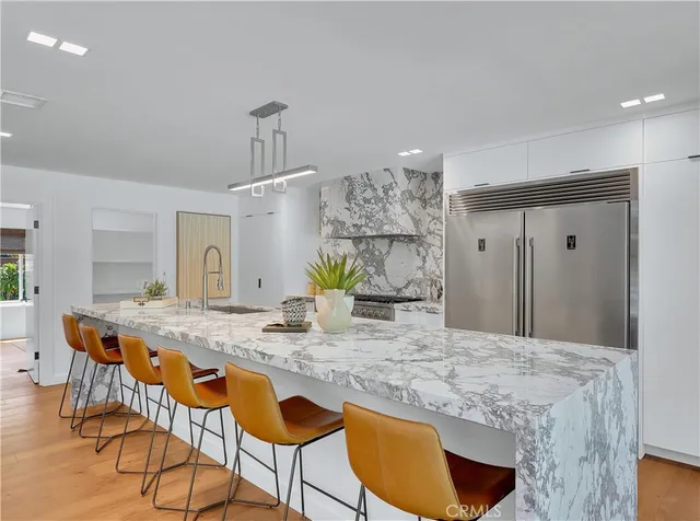 a view of a room with wooden floor and furniture