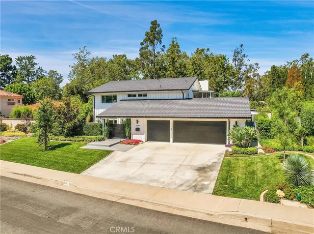 an aerial view of a house with swimming pool patio and outdoor seating