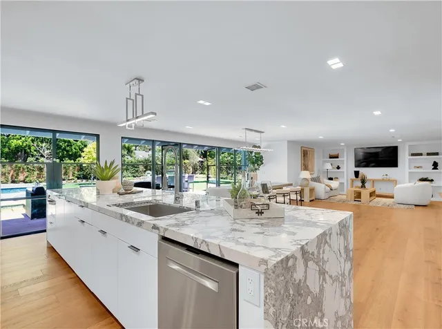 a bathroom with a double vanity sink a toilet and shower