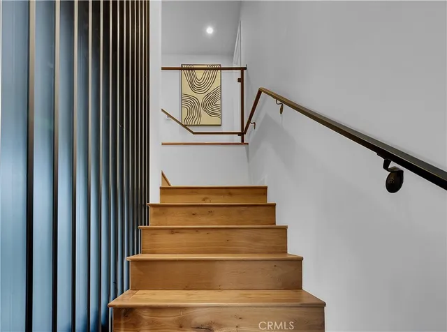 a bedroom with a bed window and a night stand