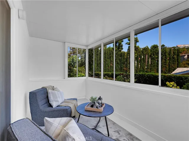 a living room with furniture and floor to ceiling windows