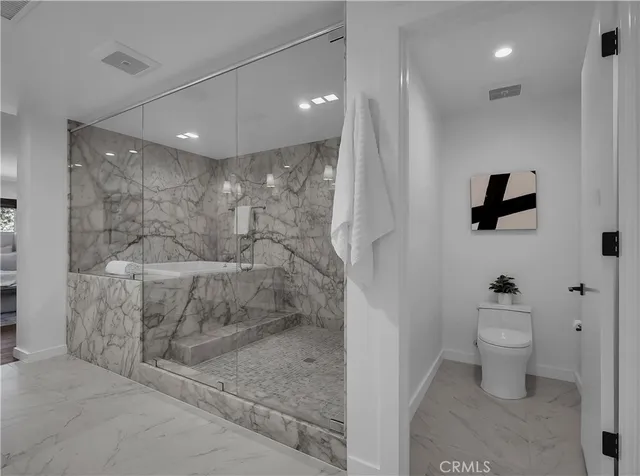 a view of a patio with a dining table and chairs with wooden floor