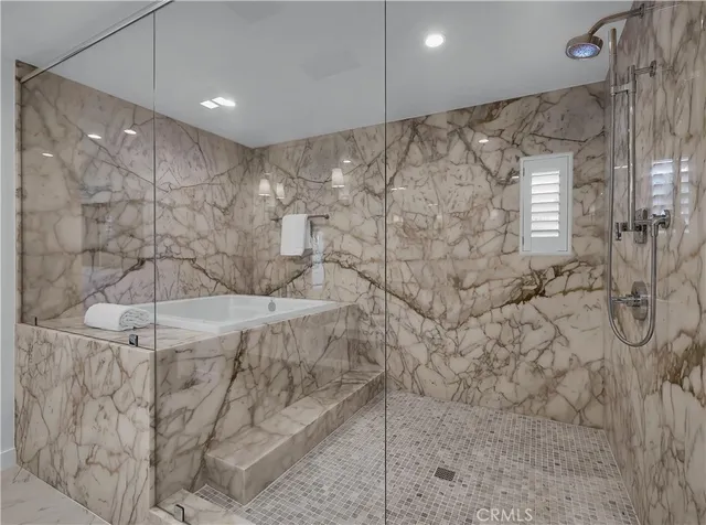 a swimming pool view with a seating space