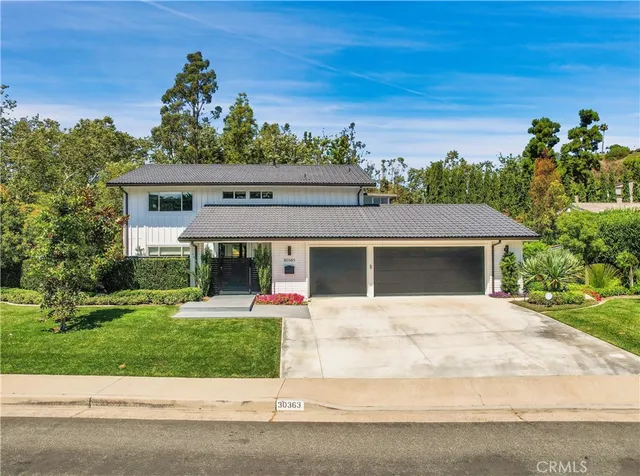 a front view of a house with a garden
