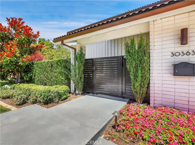 a flower garden is sitting in front of a house