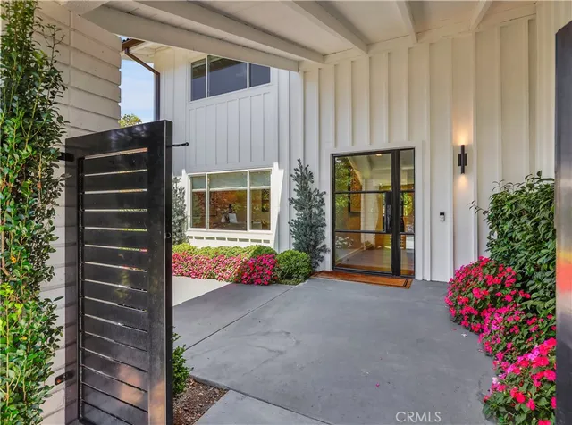 a view of a hallway with wooden floor and stairs