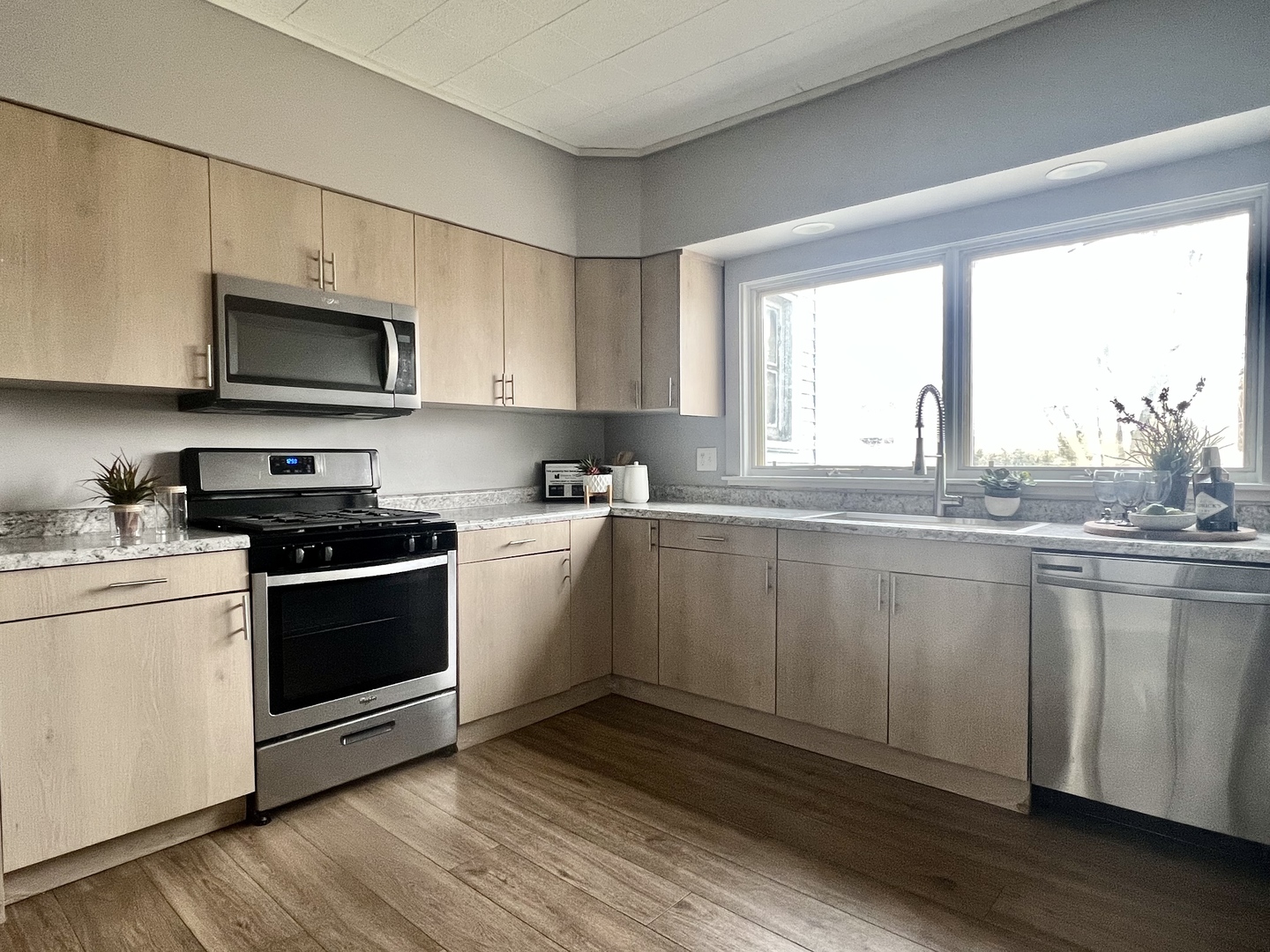 7113 Clarendon Hills Road Darien, IL 60561 - Photo 13 of 35 a kitchen with granite countertop a stove a sink and a microwave
