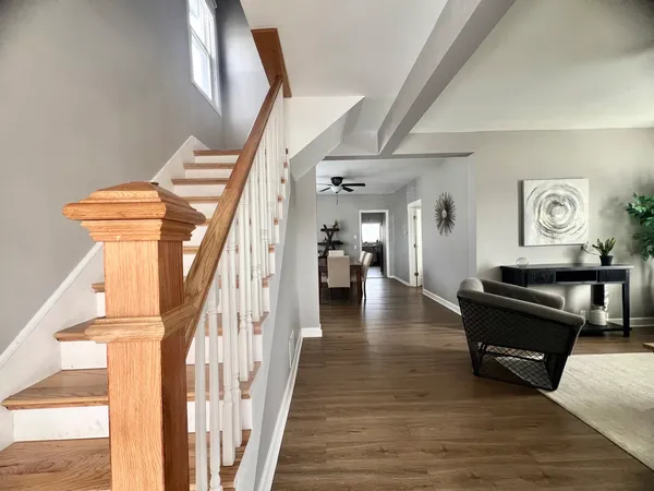 a view of entryway and hall with wooden floor