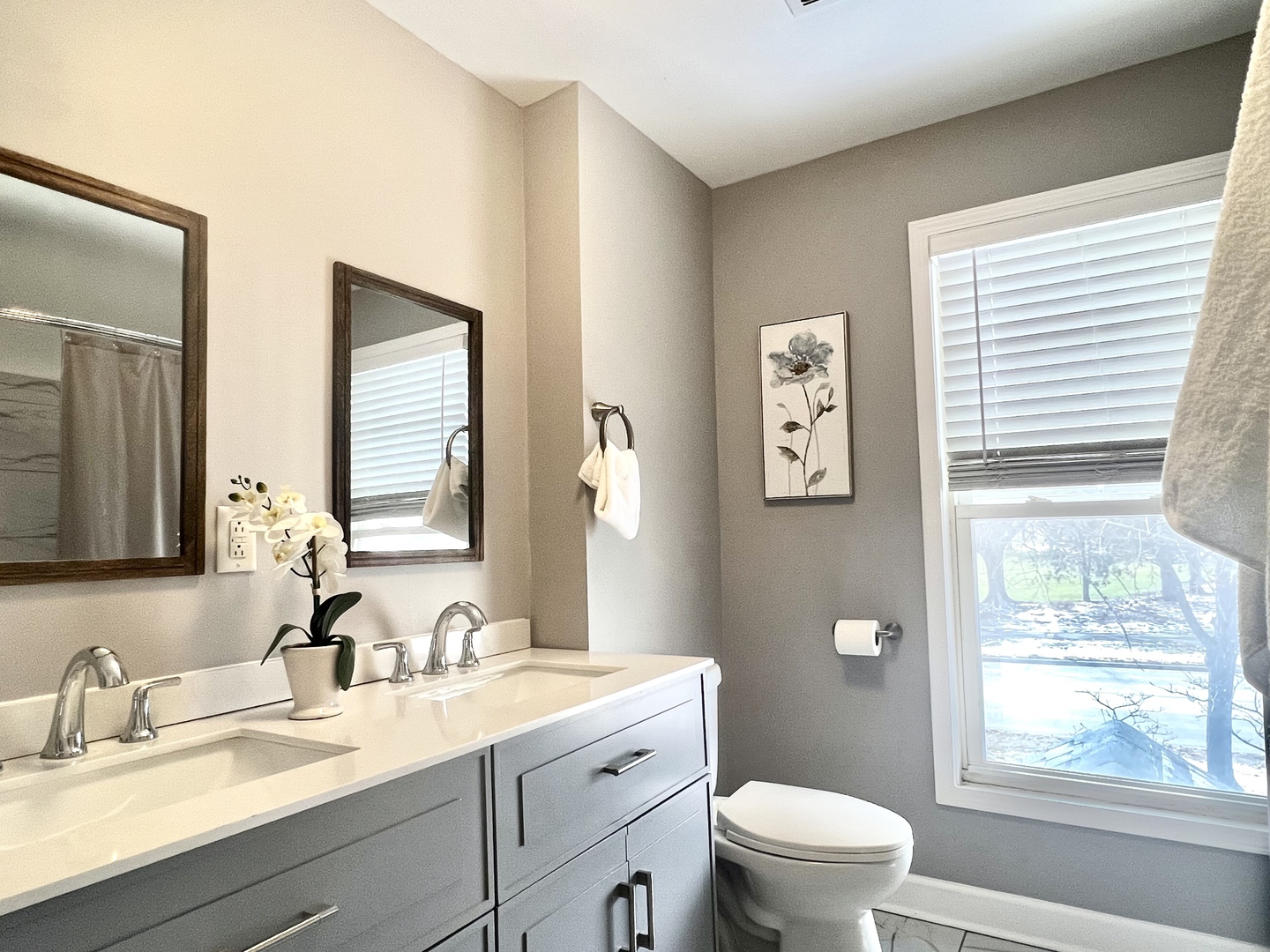 7113 Clarendon Hills Road Darien, IL 60561 - Photo 21 of 35 a bathroom with a granite countertop toilet a sink a mirror and a window