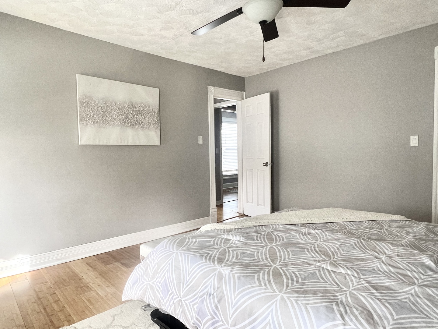 7113 Clarendon Hills Road Darien, IL 60561 - Photo 24 of 35 a bedroom with a large bed and a chandelier