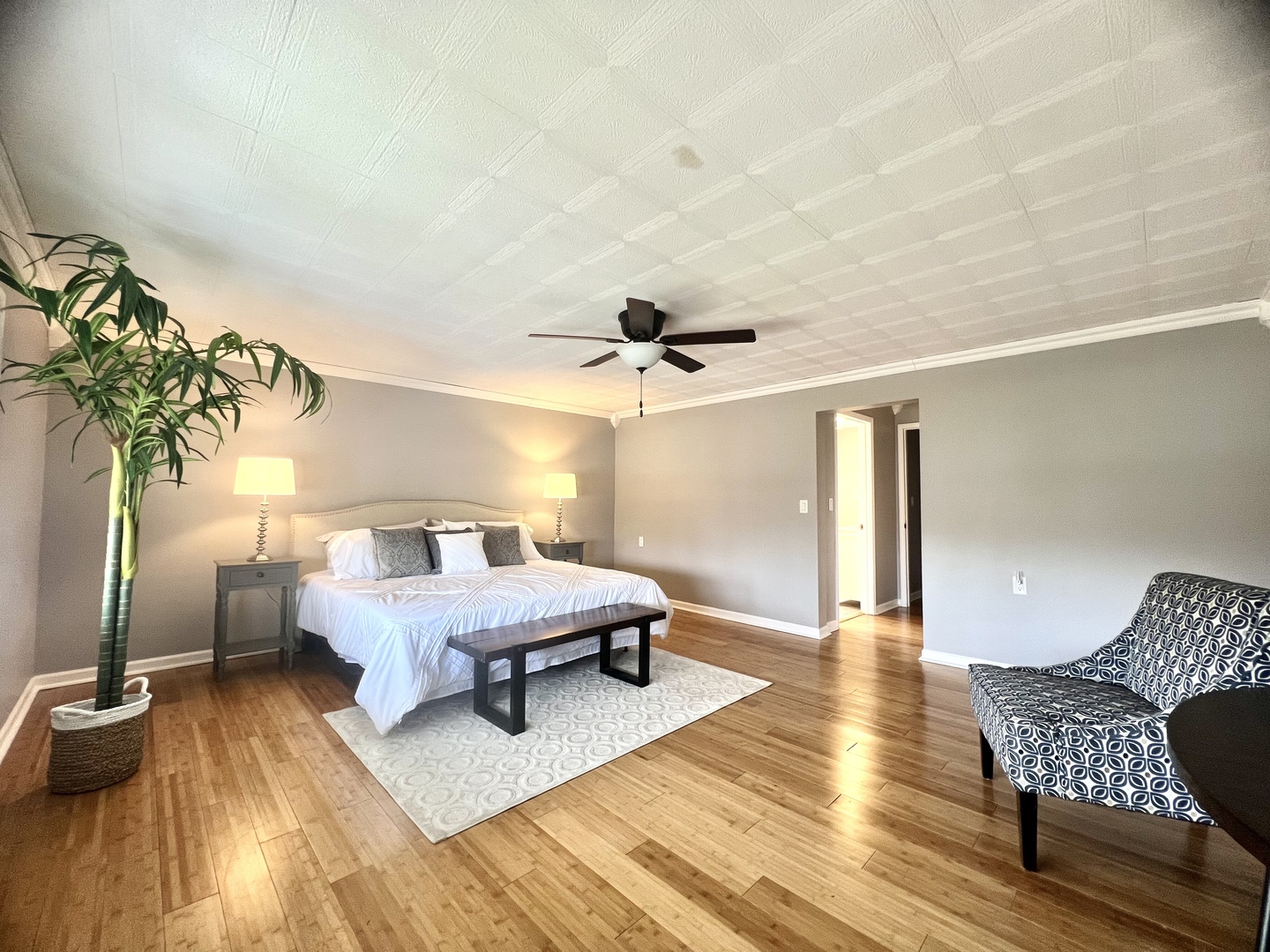 7113 Clarendon Hills Road Darien, IL 60561 - Photo 31 of 35 a spacious bedroom with a bed and a chandelier