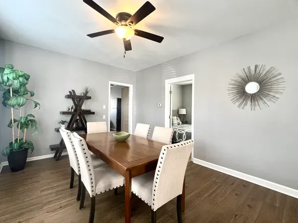 a view of a dining room with furniture and wooden floor