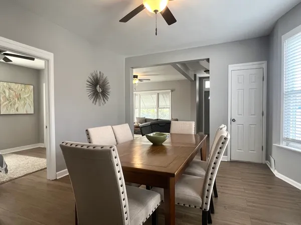 a view of a dining room with furniture and wooden floor