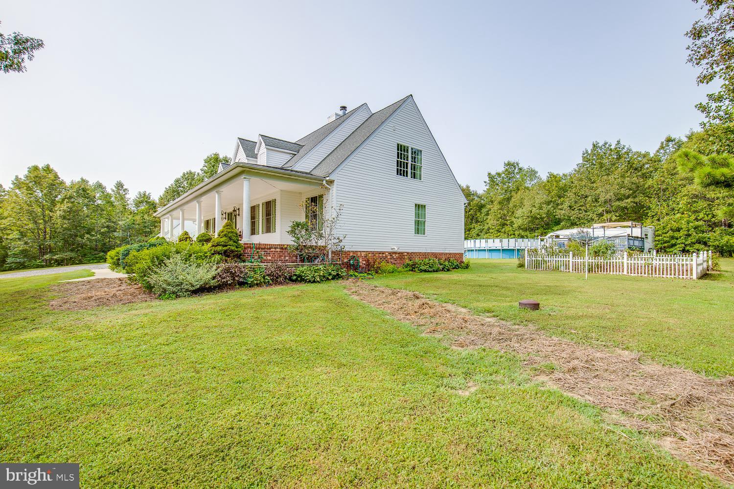 23210 Friendship Road Ruther Glen, VA 22546 - Photo 48 of 58 Side of house with view of garden and pool