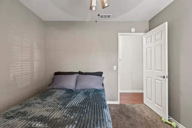 a bedroom with a bed and a rug