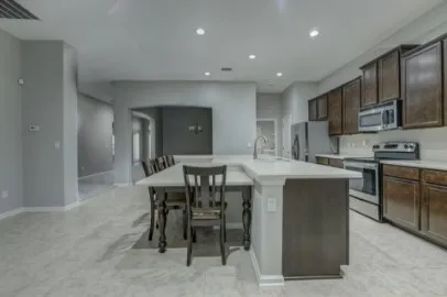 a kitchen with a table and chairs in it