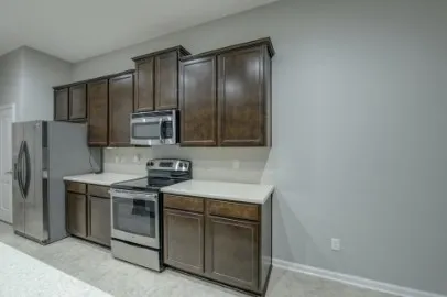 a kitchen with stainless steel appliances granite countertop a stove a refrigerator and a sink