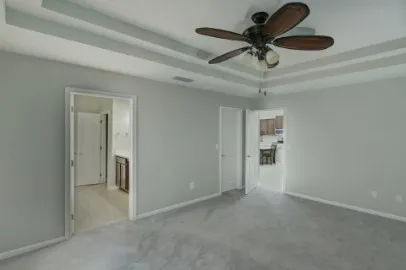 a view of a livingroom with a ceiling fan and window