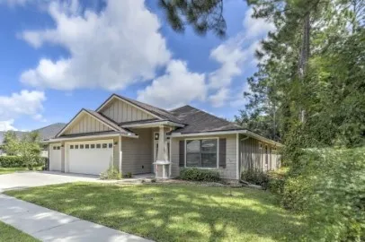 a view of a house with a yard and garage