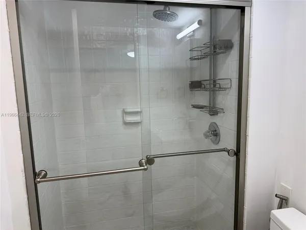 a bathroom with a glass shower door