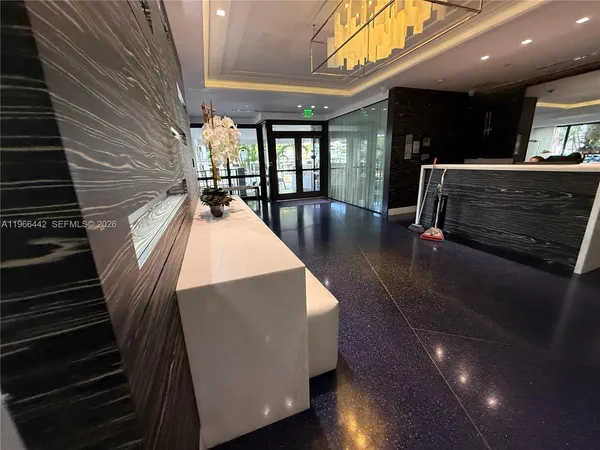 a view of a lobby with furniture and floor to ceiling window