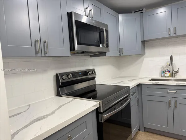 a kitchen with a sink and a microwave
