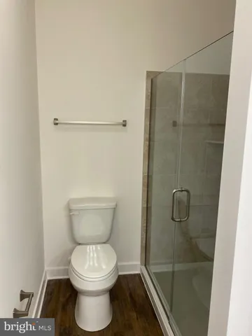 a bathroom with a toilet and a shower