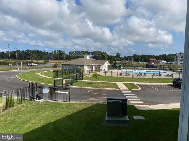 a view of a swimming pool with a yard