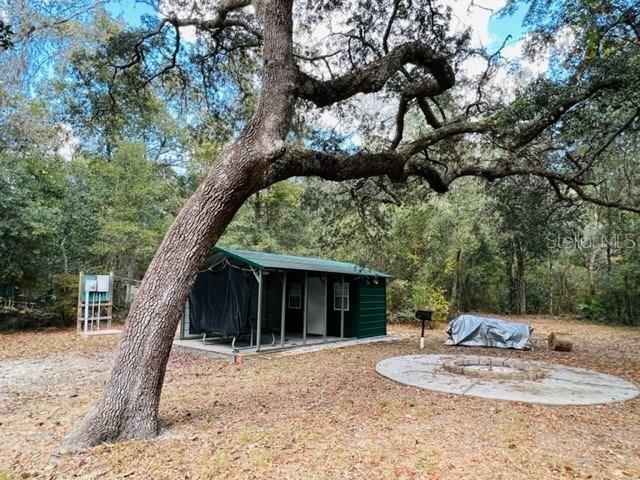 a backyard of a house with table and chairs
