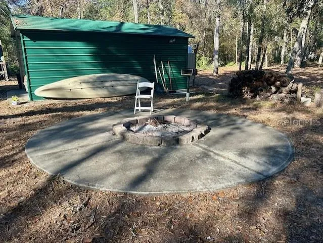 a view of backyard with wooden fence