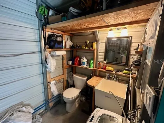 a bathroom with a toilet a sink and a shower