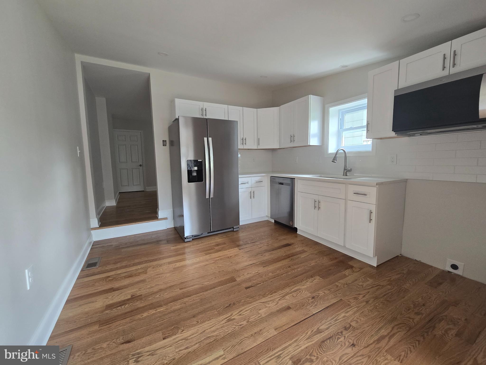 2540 Mount Road, Unit A Aston, PA 19014 - Photo 5 of 14 a view of a kitchen with wooden floor electronic appliances and window