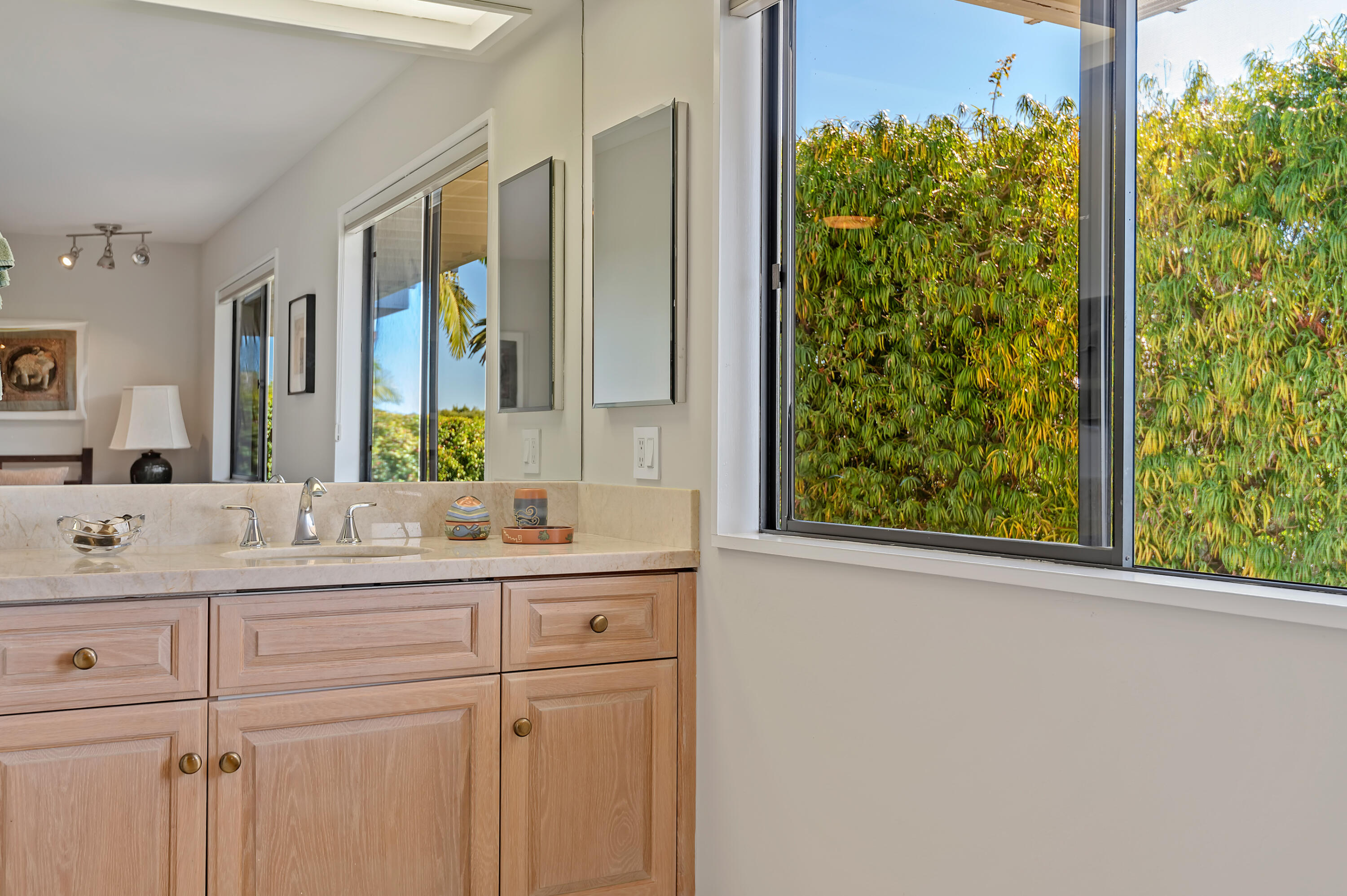 10 Rincon Vista Road Santa Barbara, CA 93103 - Photo 28 of 40 a bathroom with a granite countertop sink and a mirror