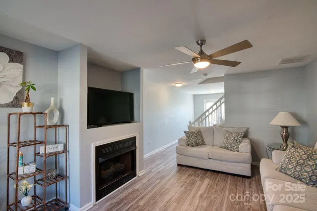 a living room with furniture a fireplace and a flat screen tv