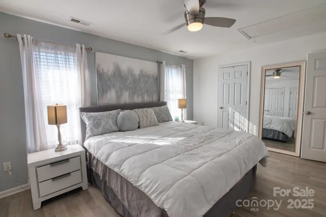 a bedroom with bed and a chandelier