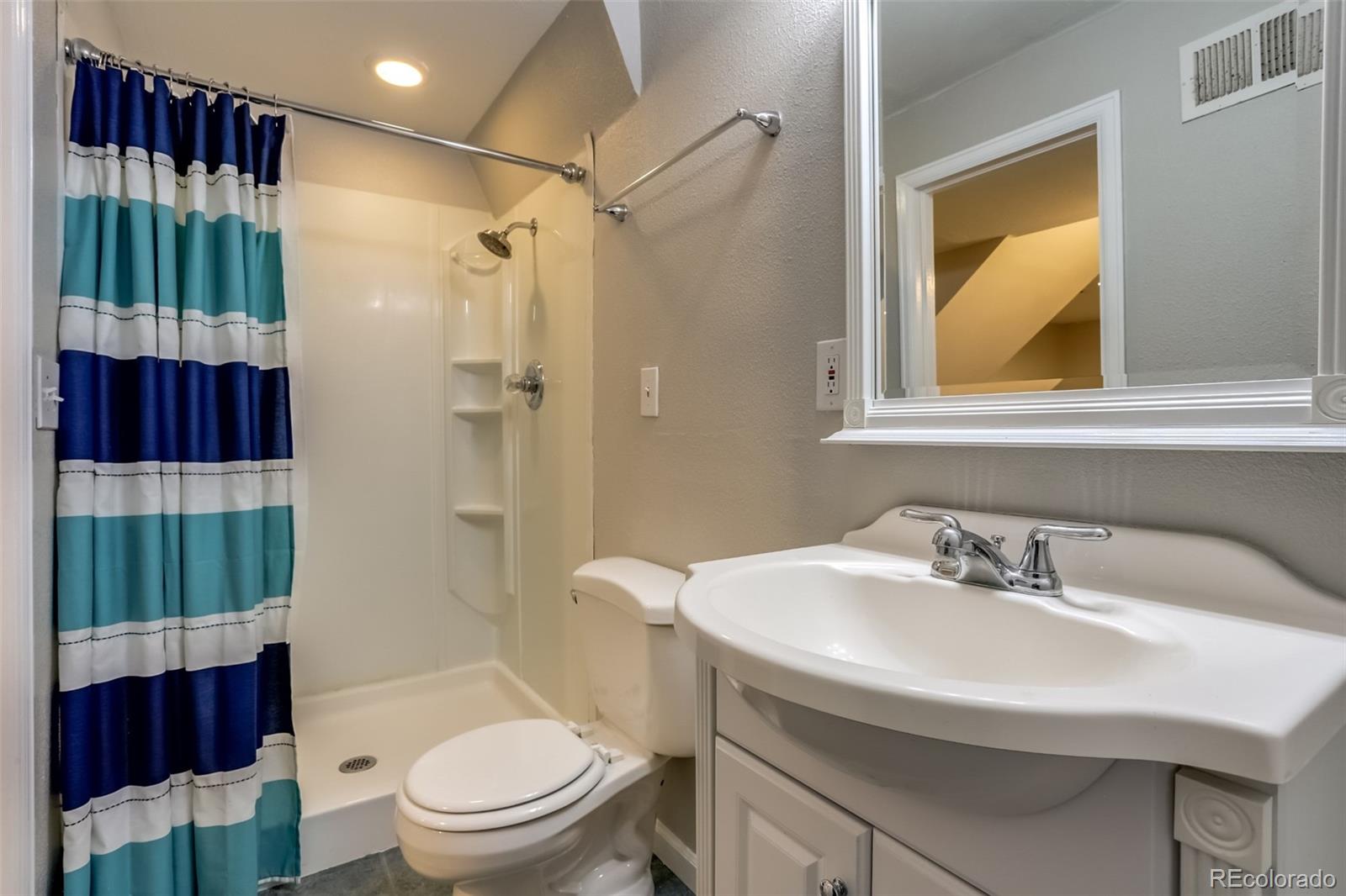 514 Longfellow Lane Highlands Ranch, CO 80126 - Photo 14 of 43 a bathroom with a sink a toilet and shower